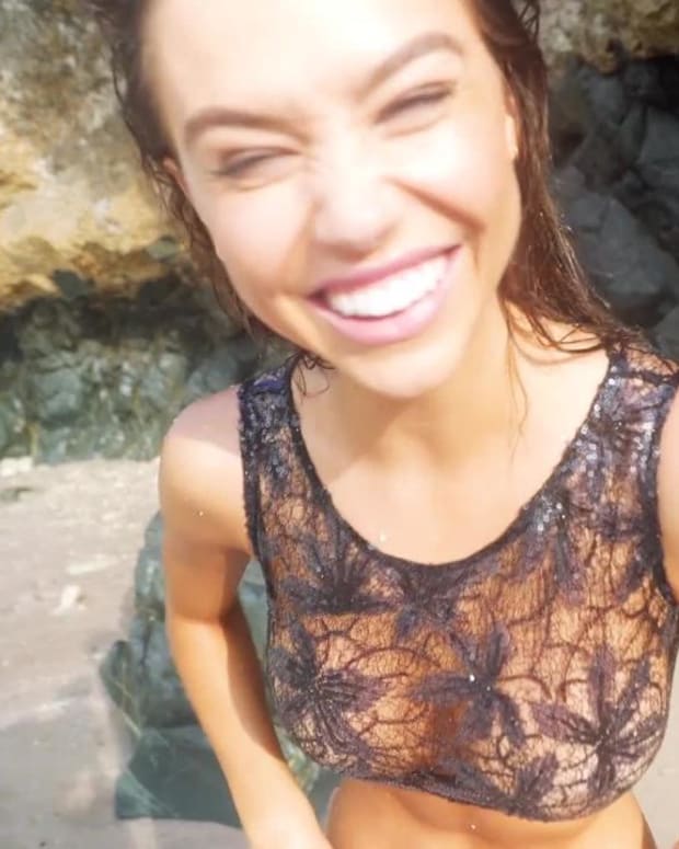 Alexis Ren gets hit by a big wave in Aruba
